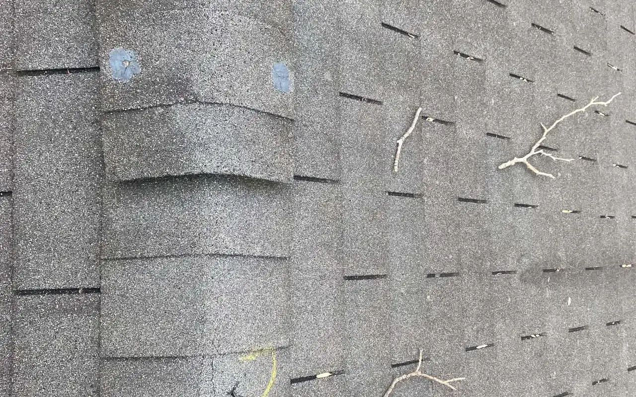 Close-up of shingles marked during a roof inspection